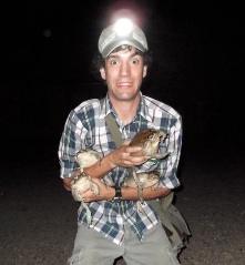 man holding frogs